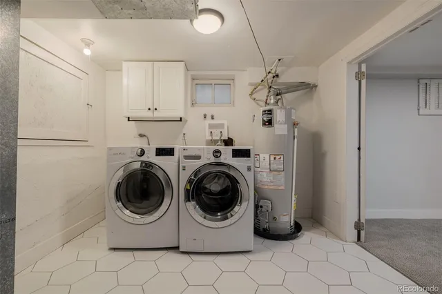 a utility room with sink dryer and washer