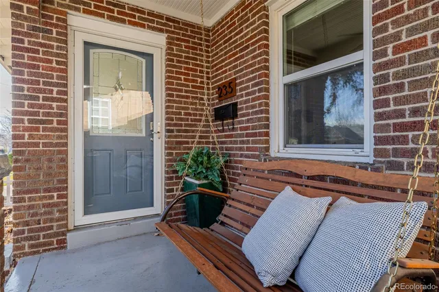 a view of house with backyard and furniture