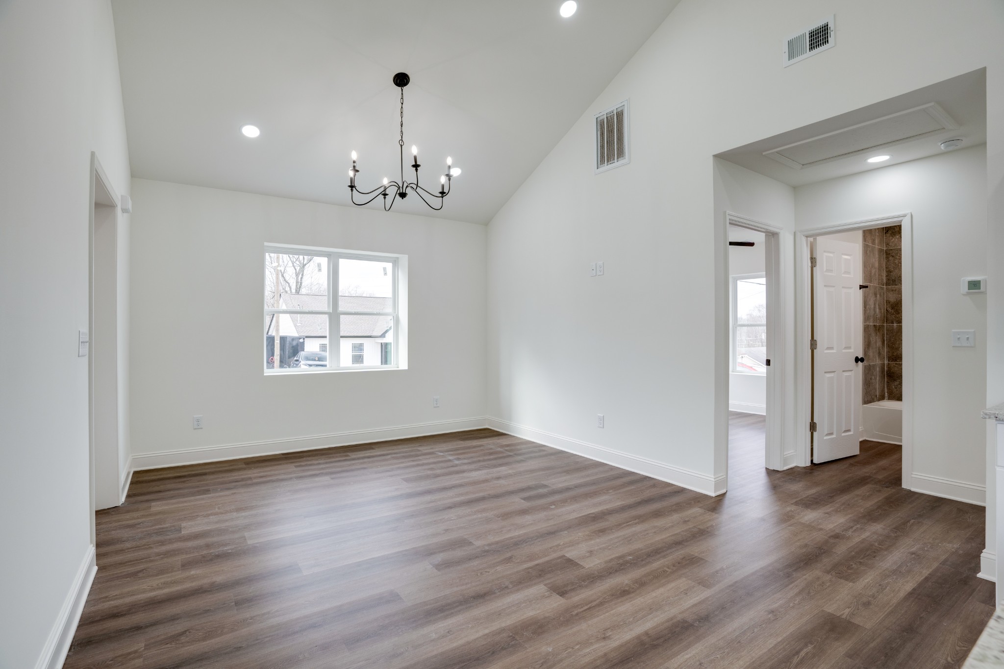 514 Smith Street Springfield, TN 37172 - Photo 7 of 25 an empty room with wooden floor and windows