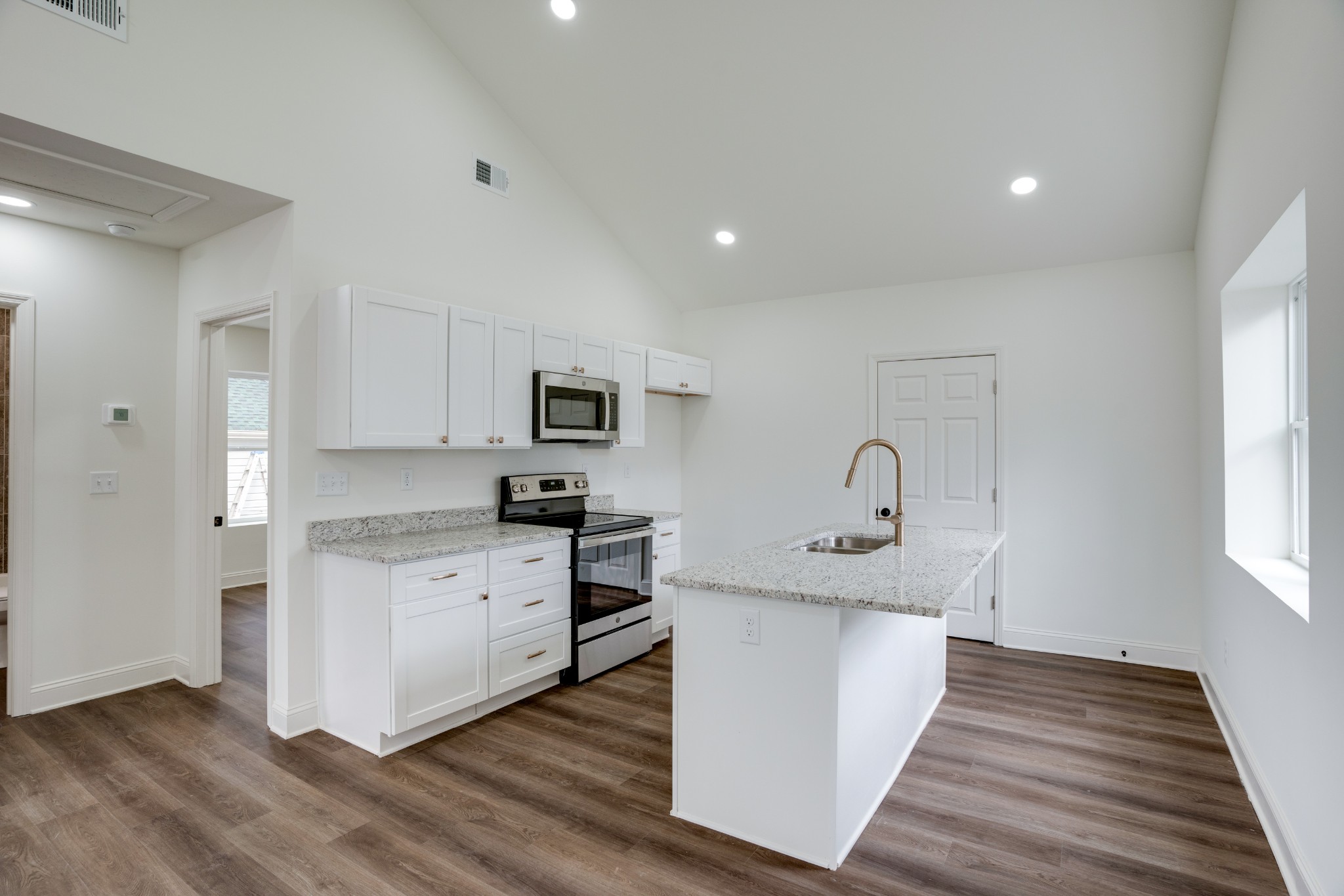 514 Smith Street Springfield, TN 37172 - Photo 9 of 25 a kitchen with stainless steel appliances granite countertop a sink stove and wooden floor