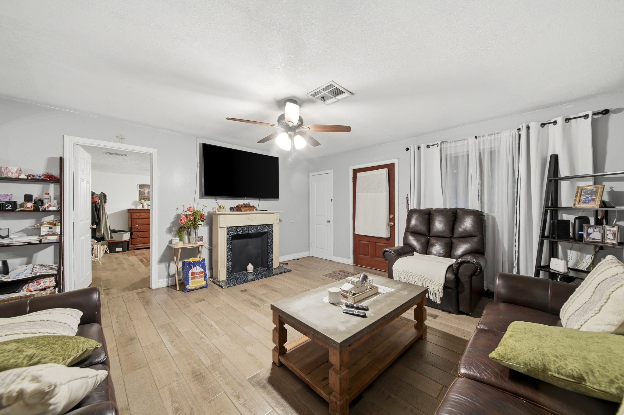 731 Meneley Road Winnie, TX 77665 - Photo 4 of 27 a living room with furniture a fireplace and a flat screen tv