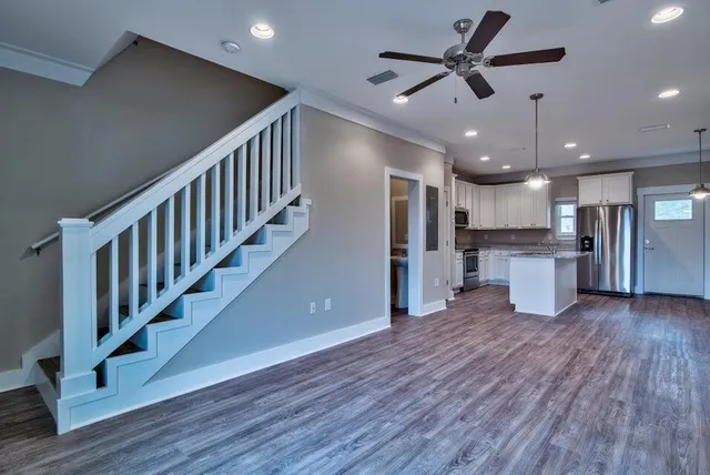 a view of kitchen with stainless steel appliances refrigerator oven stove microwave and cabinets