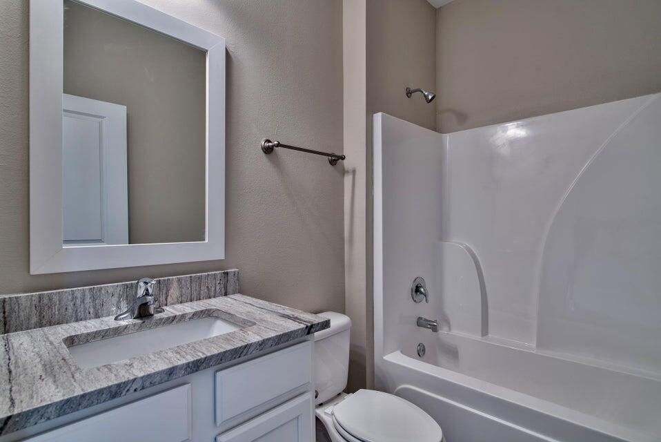 45 North Sand Palm Road Freeport, FL 32439 - Photo 14 of 32 a bathroom with a granite countertop sink toilet and shower