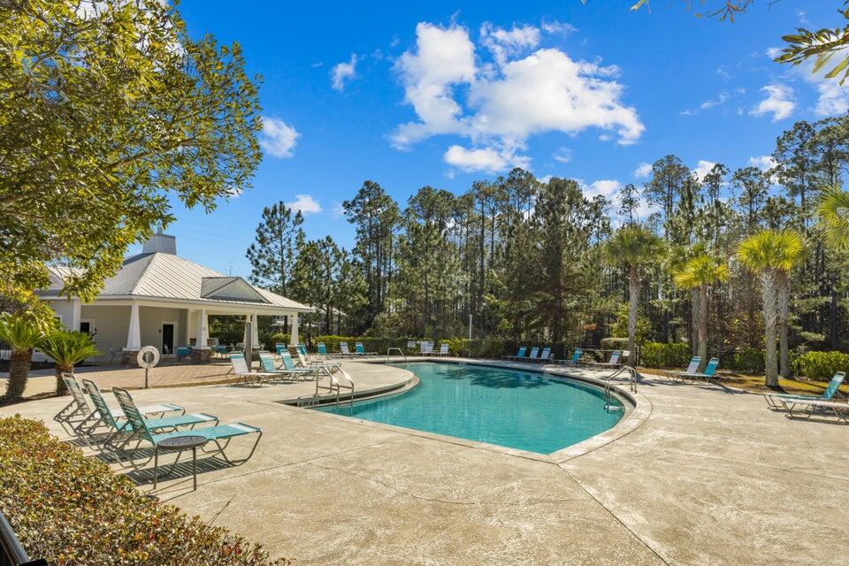 45 North Sand Palm Road Freeport, FL 32439 - Photo 22 of 32 a view of a white house with a swimming pool and a fire pit