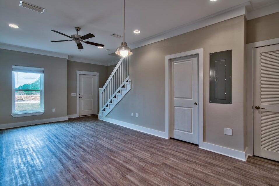 45 North Sand Palm Road Freeport, FL 32439 - Photo 4 of 32 a view of an empty room with wooden floor and a window