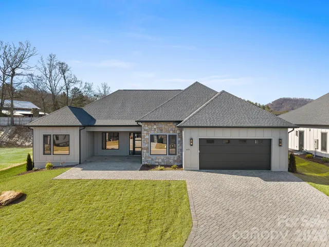 a kitchen with granite countertop a sink stove and cabinets