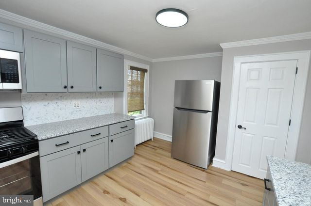a kitchen with a refrigerator sink and cabinets