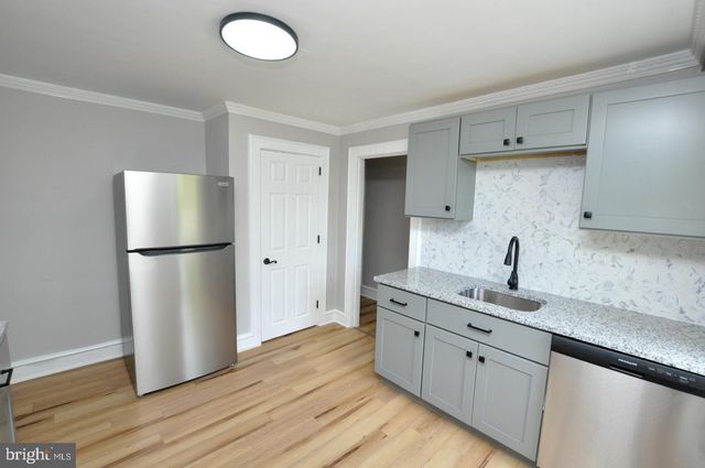 a kitchen with a refrigerator sink and cabinets