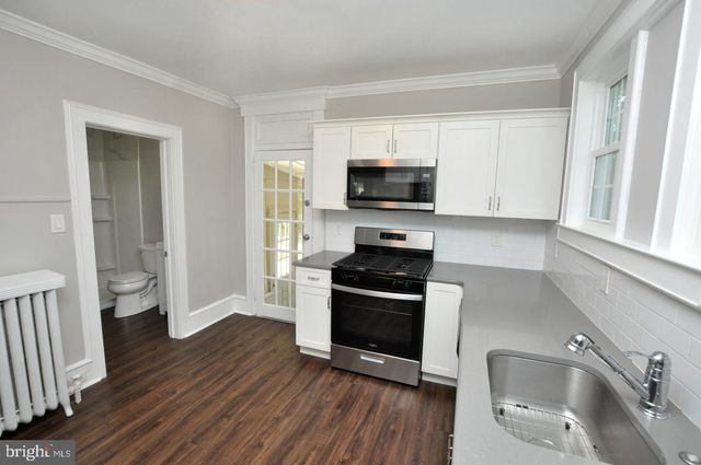 a kitchen with wooden cabinets and stainless steel appliances
