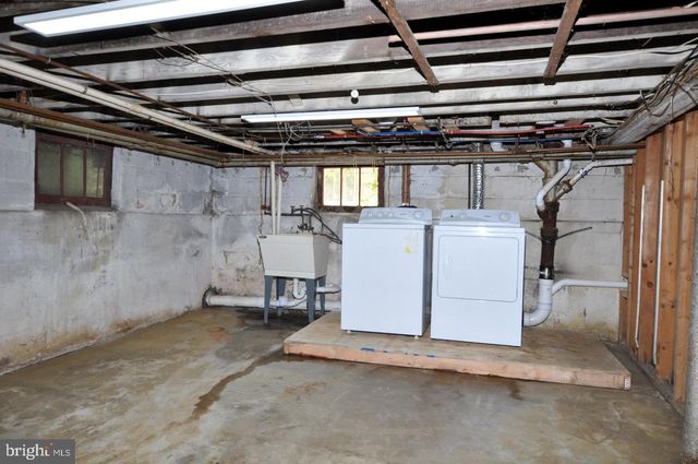 a view of a white house with a yard