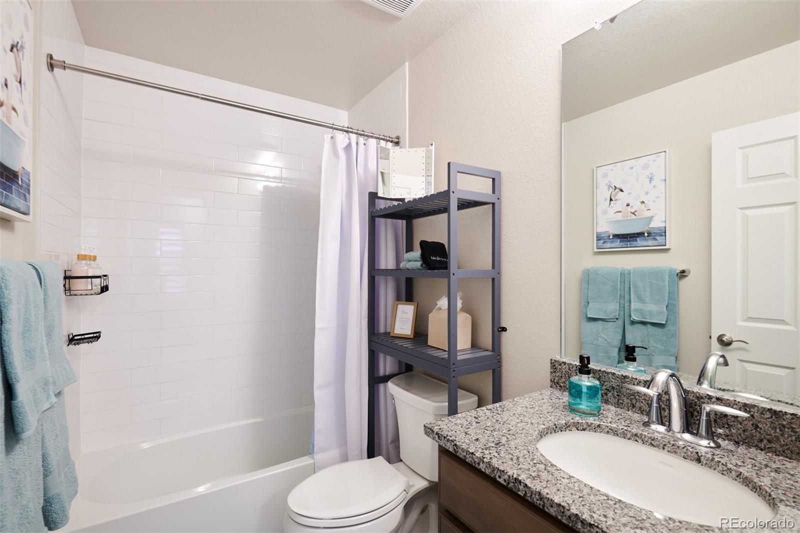 6339 North Hanover Street Denver, CO 80238 - Photo 18 of 24 a bathroom with a granite countertop sink toilet and shower