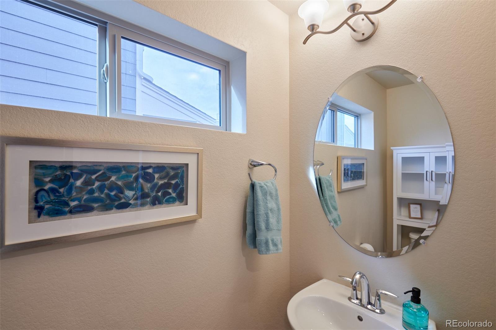 6339 North Hanover Street Denver, CO 80238 - Photo 6 of 24 a bathroom with a sink and a mirror