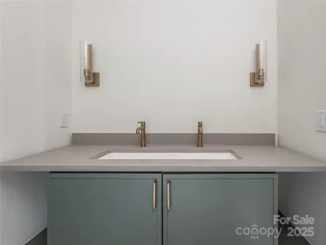 a bathroom with a sink and vanity