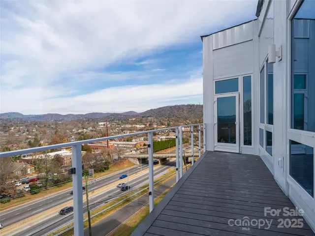 a view of a balcony with wooden floor and city view