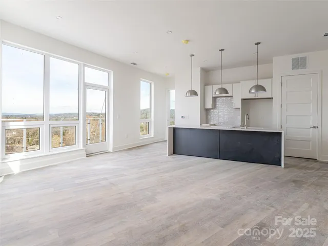 a view of a kitchen with large windows