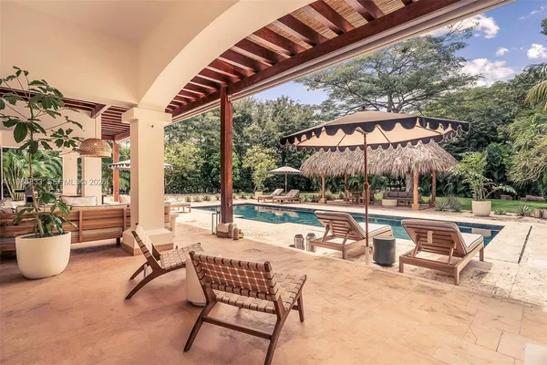 a patio with patio a table and chairs under an umbrella