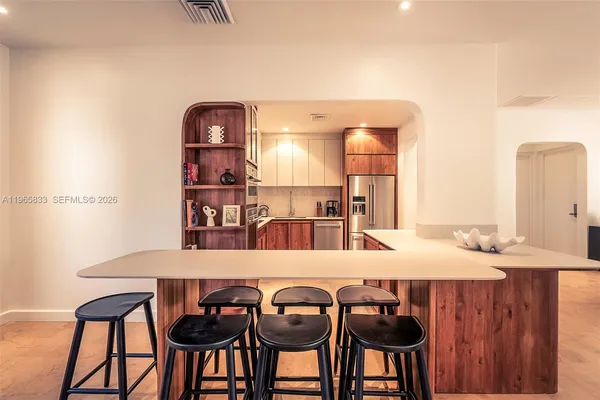 a kitchen with stainless steel appliances granite countertop a refrigerator and a stove top oven