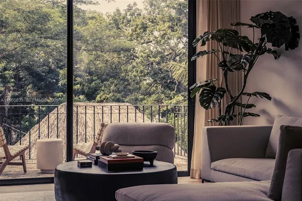 a living room with furniture and a potted plant