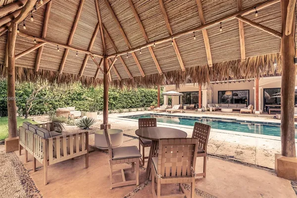 a view of a patio with a table and chairs under an umbrella