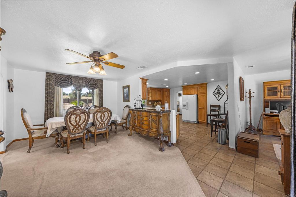 30265 Miller Road Valley Center, CA 92082 - Photo 16 of 56 a dining room with furniture and a chandelier