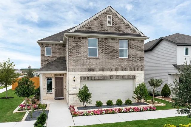 a front view of a house with a garden and plants