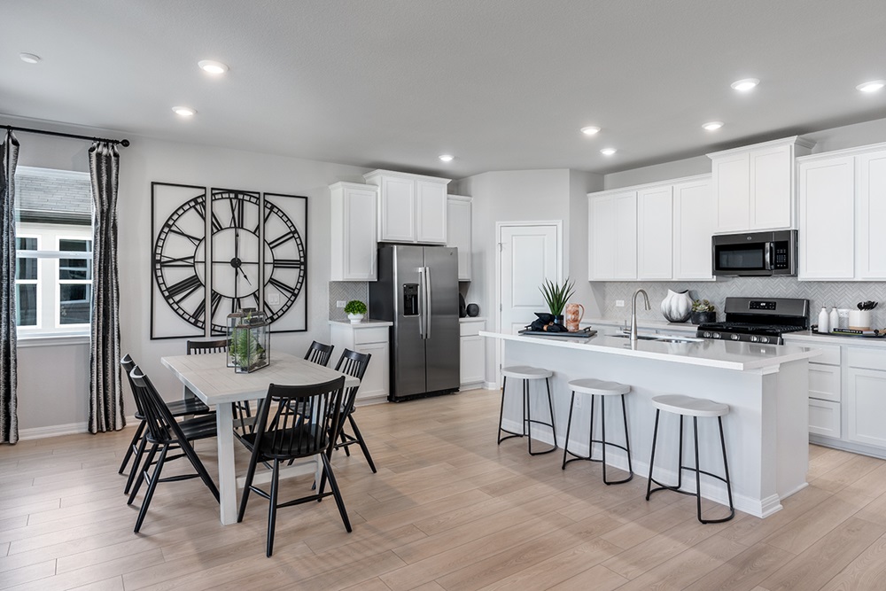 5901 Beverly Pr Road Del Valle, TX 78617 - Photo 11 of 18 a kitchen with stainless steel appliances granite countertop a stove a sink a refrigerator with a dining table and chairs