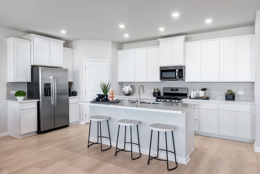 5901 Beverly Pr Road Del Valle, TX 78617 - Photo 3 of 18 a kitchen with white cabinets and stainless steel appliances