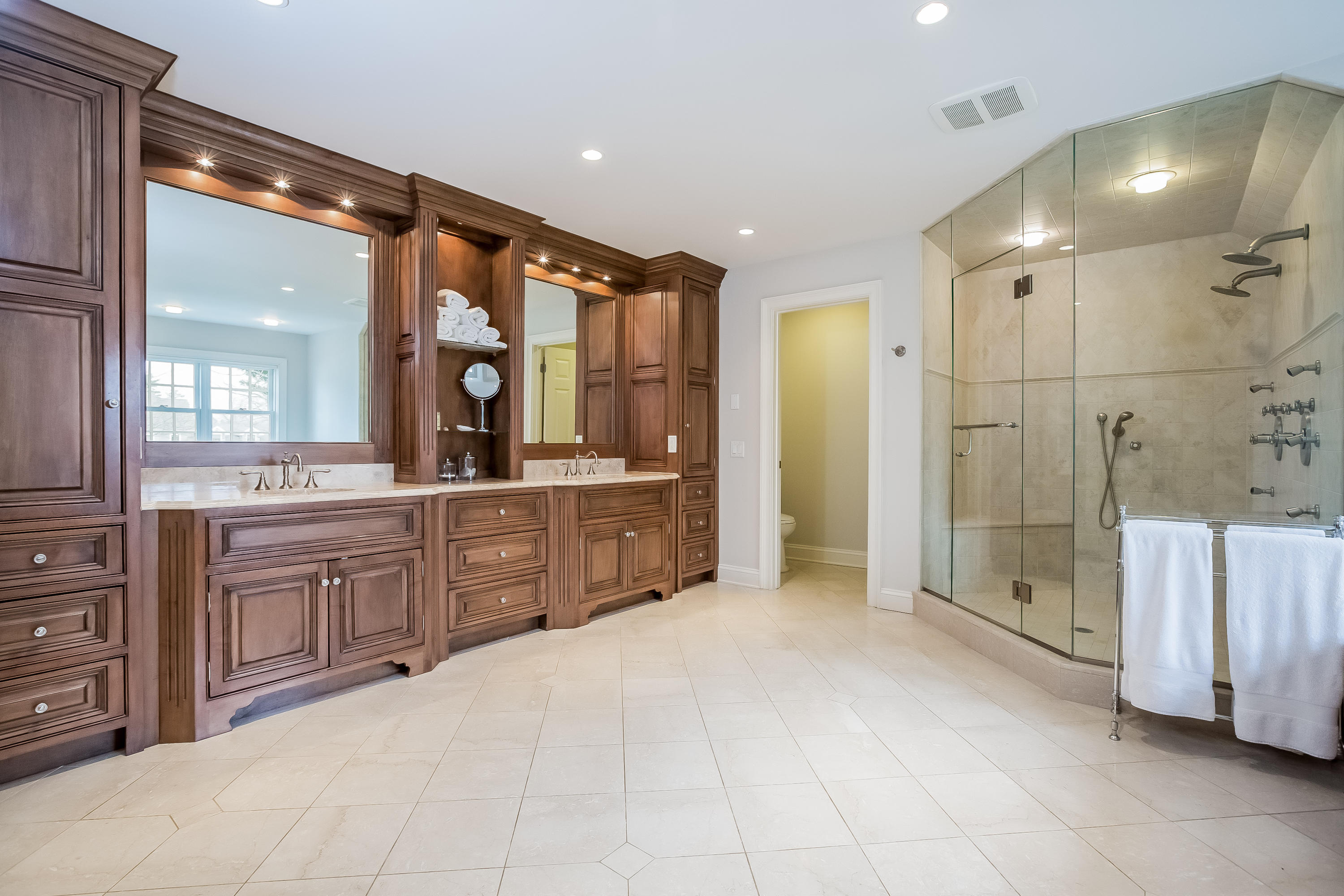 43 Gower Road New Canaan, CT 06840 - Photo 26 of 47 a large bathroom with a large mirror vanity and shower