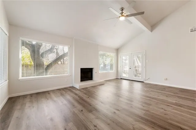 wooden floor in an empty room with a window