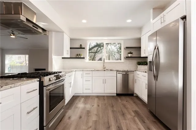 a kitchen with a stove a sink and a refrigerator