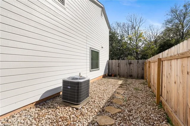 a view of a backyard with wooden fence