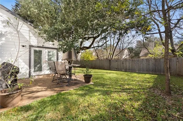 a view of a backyard with table and chairs and a slide