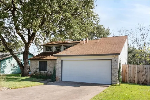 a aerial view of a house with a yard and garage