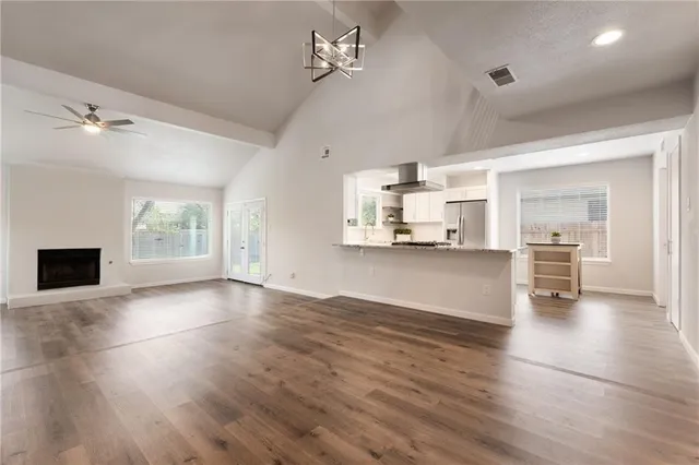 a view of a kitchen with wooden floor and a kitchen space