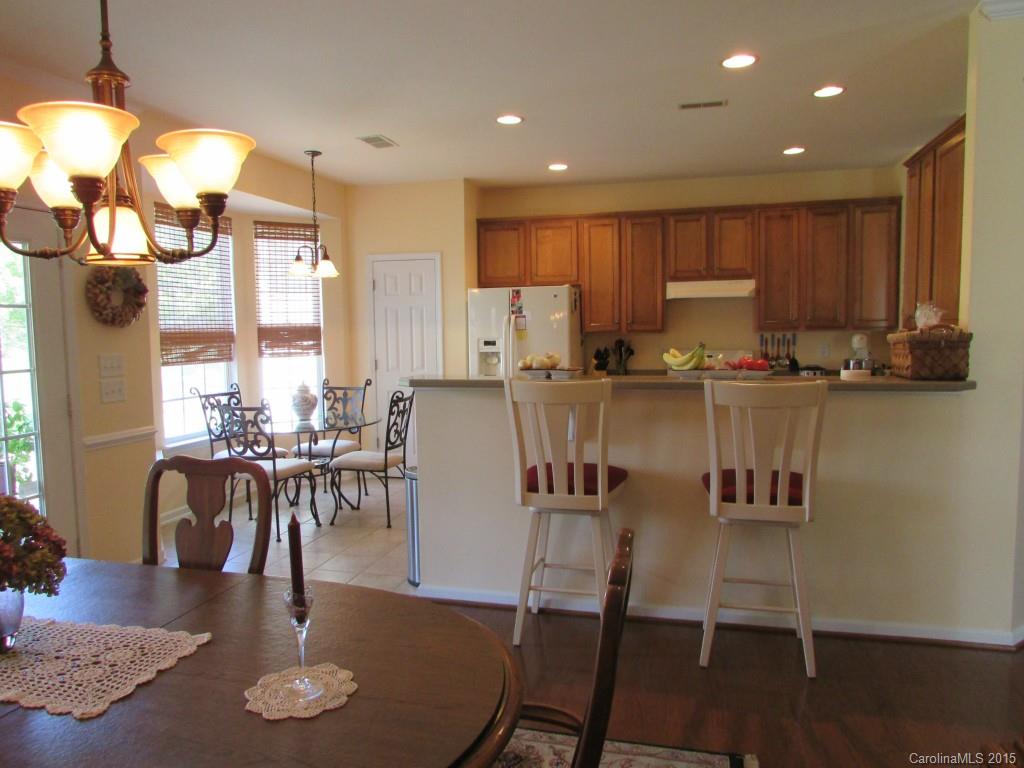 769 Platinum Drive Fort Mill, SC 29708 - Photo 13 of 19 a kitchen with stainless steel appliances granite countertop a table chairs sink and cabinets