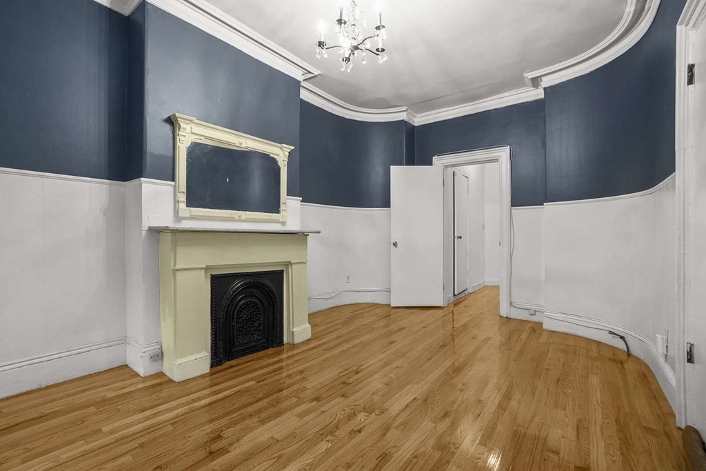 a bedroom with a bed and a fireplace