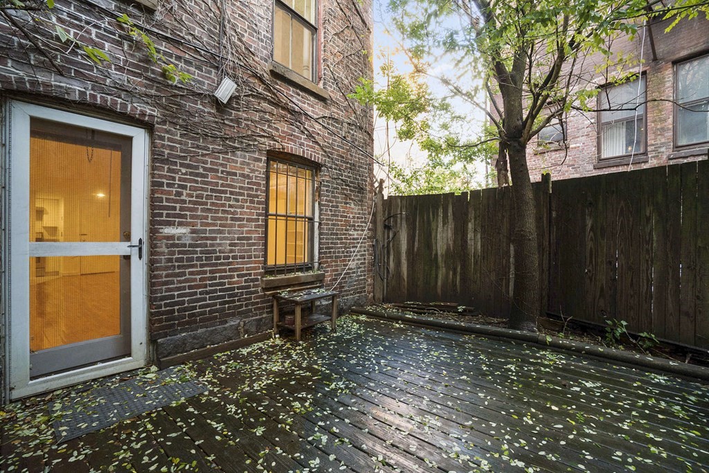 6 Dwight Street, Unit 1 Boston, MA 02118 - Photo 15 of 20 a view of backyard with brick wall and potted plants