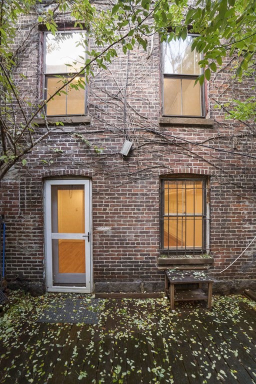 6 Dwight Street, Unit 1 Boston, MA 02118 - Photo 16 of 20 a front view of a house with a blue gate