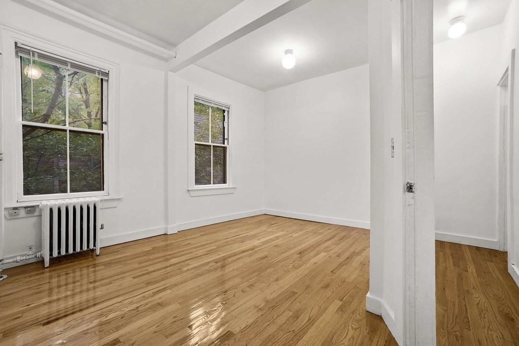 6 Dwight Street, Unit 1 Boston, MA 02118 - Photo 6 of 20 a view of an empty room with wooden floor and a window