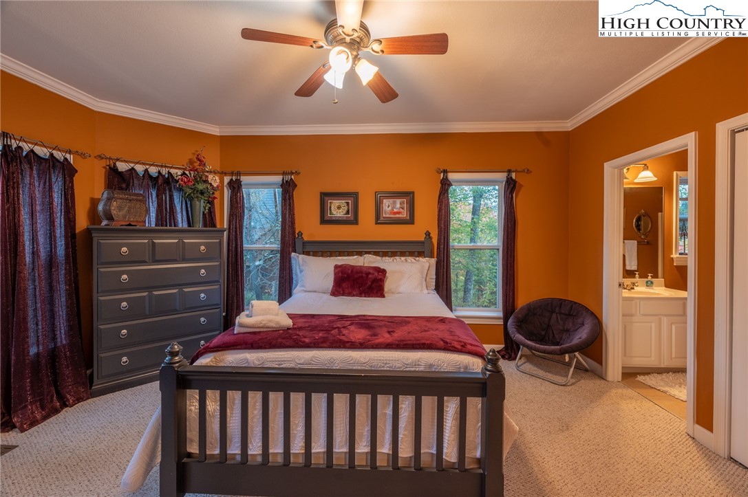 309 Pinnacle Ridge Road Beech Mountain, NC 28604 - Photo 21 of 45 a bedroom with a bed and a chandelier