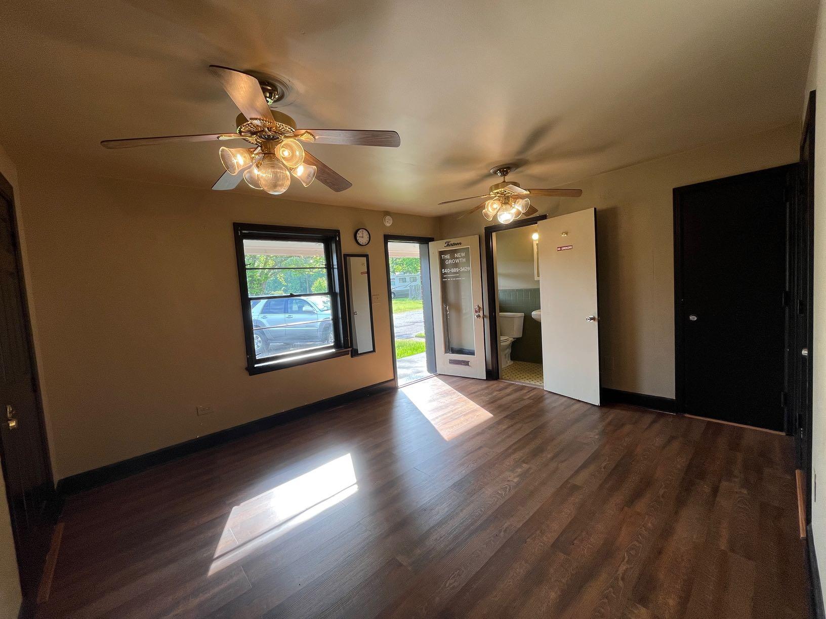 7629 Williamson Road, Unit 13 Roanoke, VA 24019 - Photo 4 of 4 a view of an empty room with a window and wooden floor