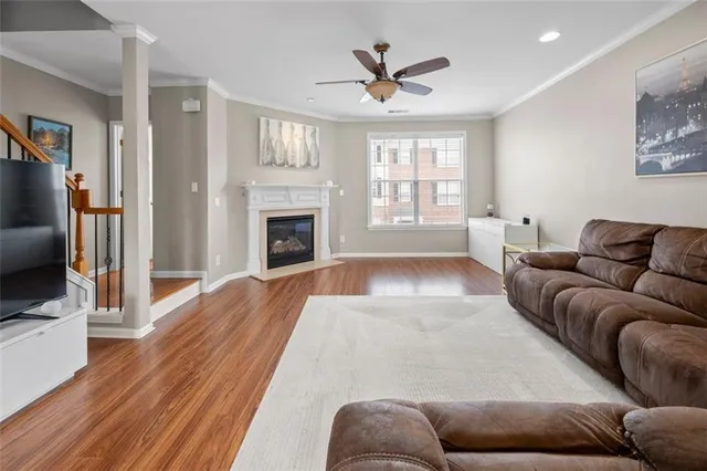 a living room with furniture fireplace and a window
