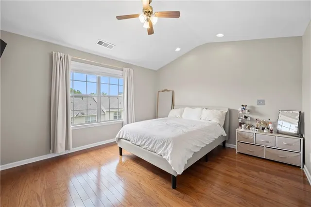 a spacious bedroom with a bed and a window