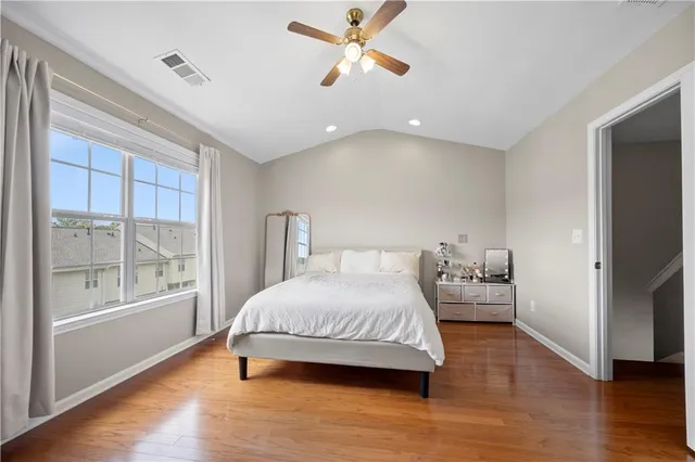 a bedroom with a bed and a large window