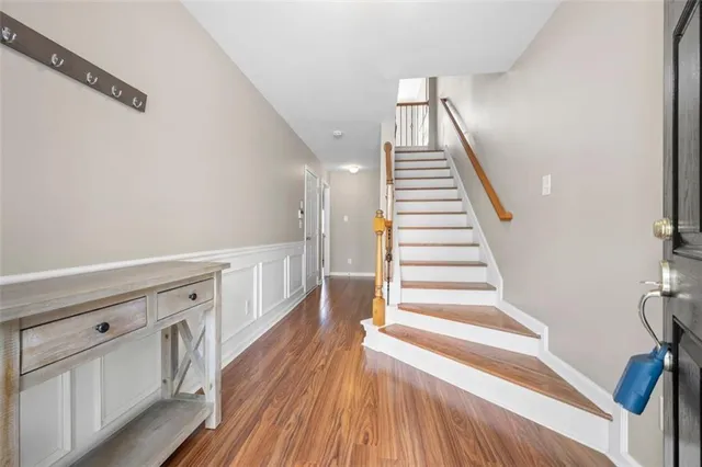 a view of entryway and hall with wooden floor