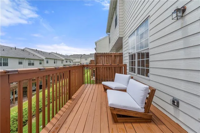 a view of balcony with wooden floor and outdoor seating