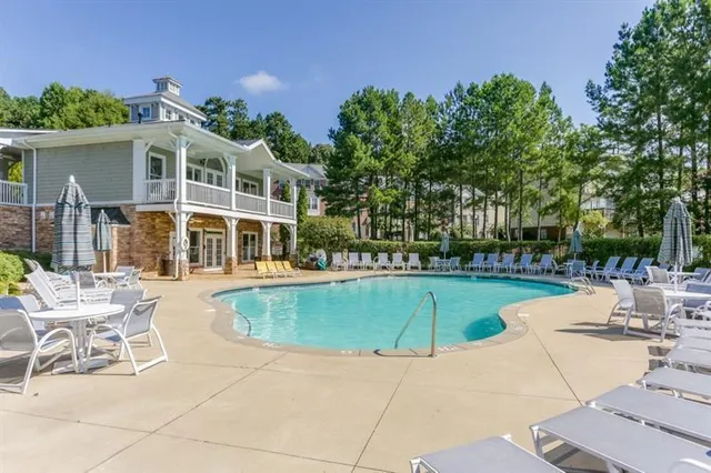 a view of a house with swimming pool and sitting area