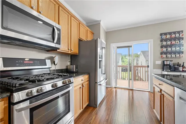 a kitchen with stainless steel appliances granite countertop a stove and a refrigerator