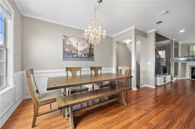 a view of a dining room with furniture and wooden floor