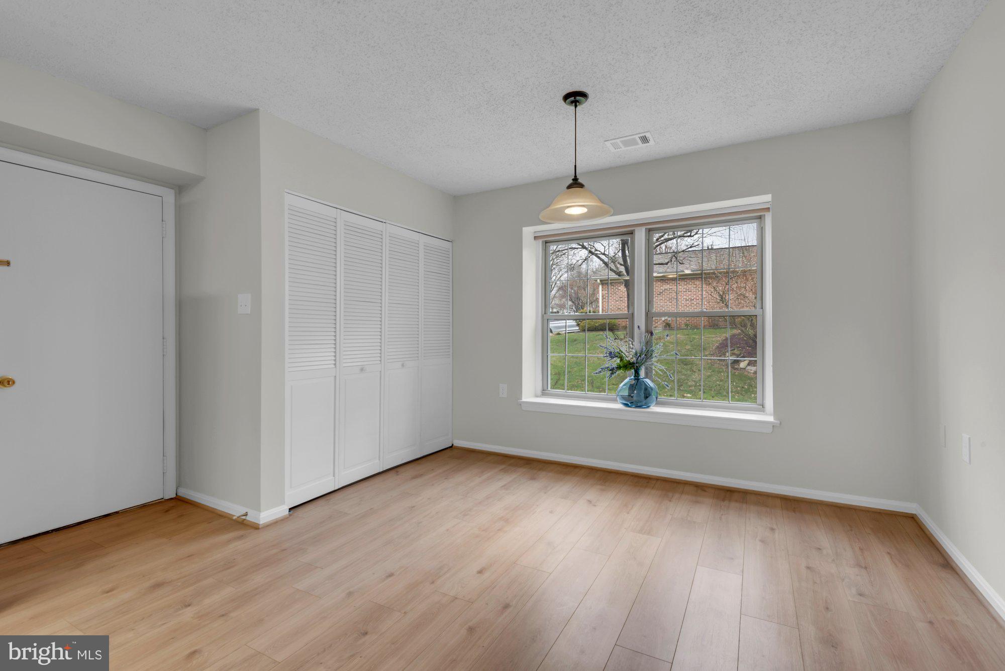 2572 Golfers Ridge Road Annapolis, MD 21401 - Photo 21 of 69 an empty room with wooden floor and windows
